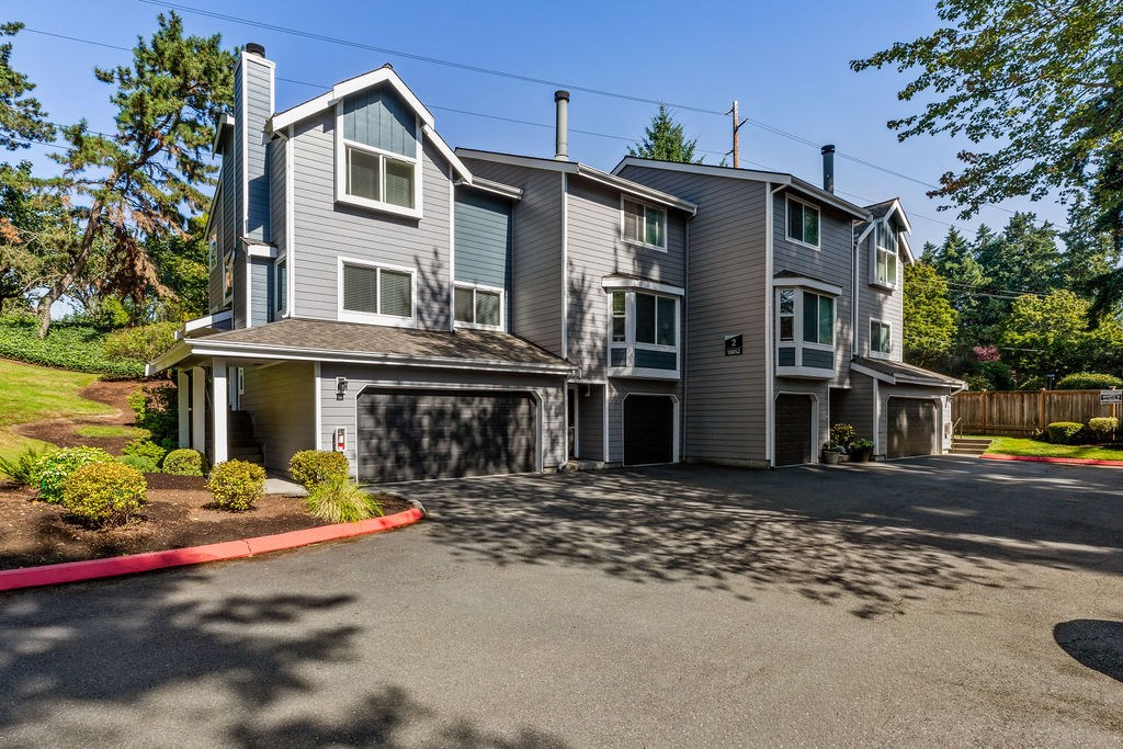 A large two-story house with a garage and a driveway.