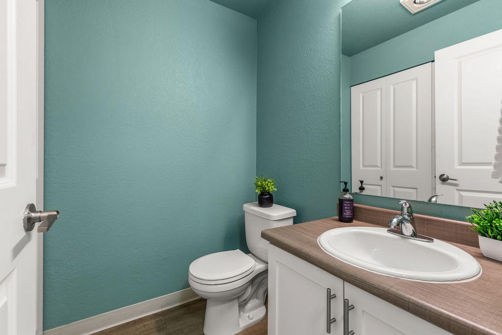 A white toilet sits next to a sink in a bathroom.