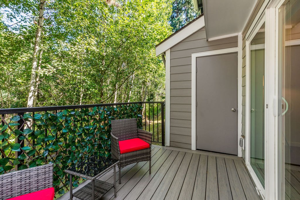 A balcony with a chair and a table.
