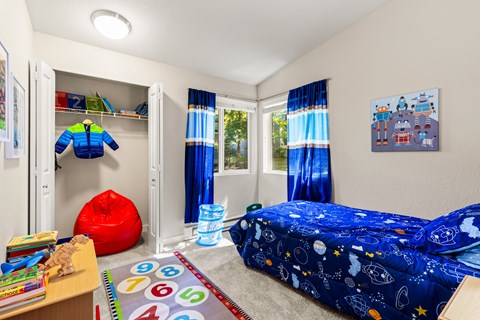 Kids bedroom with space themed bedding and toys at Hubbard's Crossing Apartments, Washington