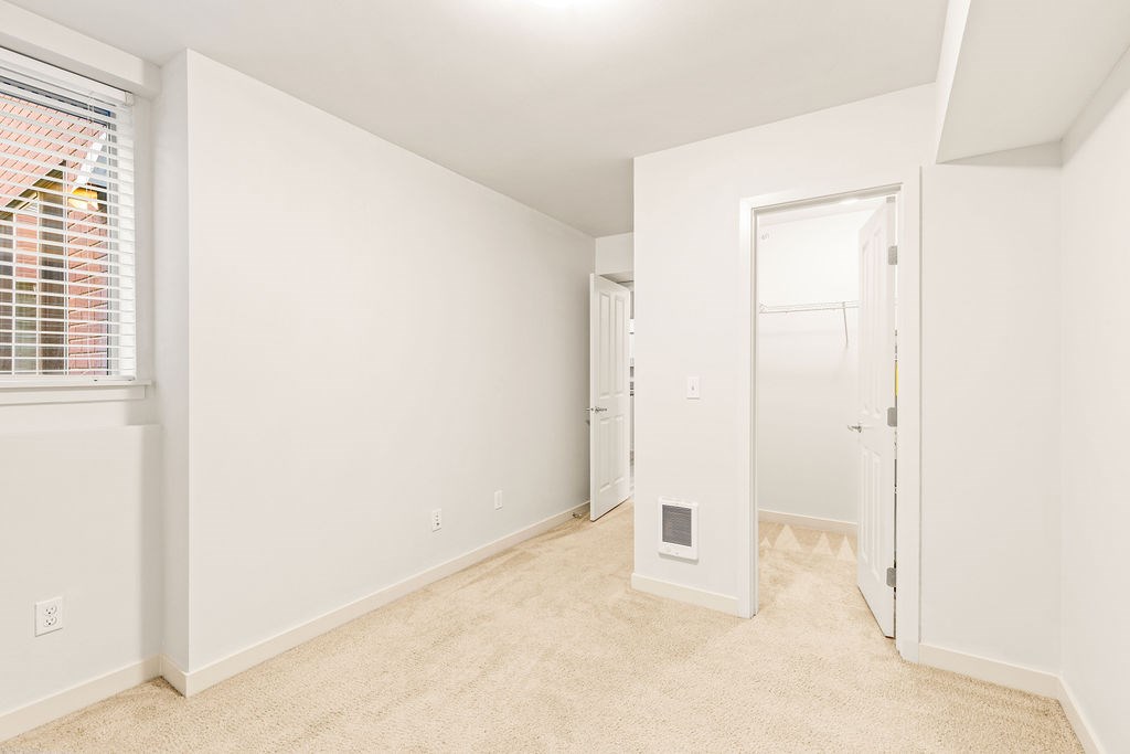 A white room with a doorway leading to another room.
