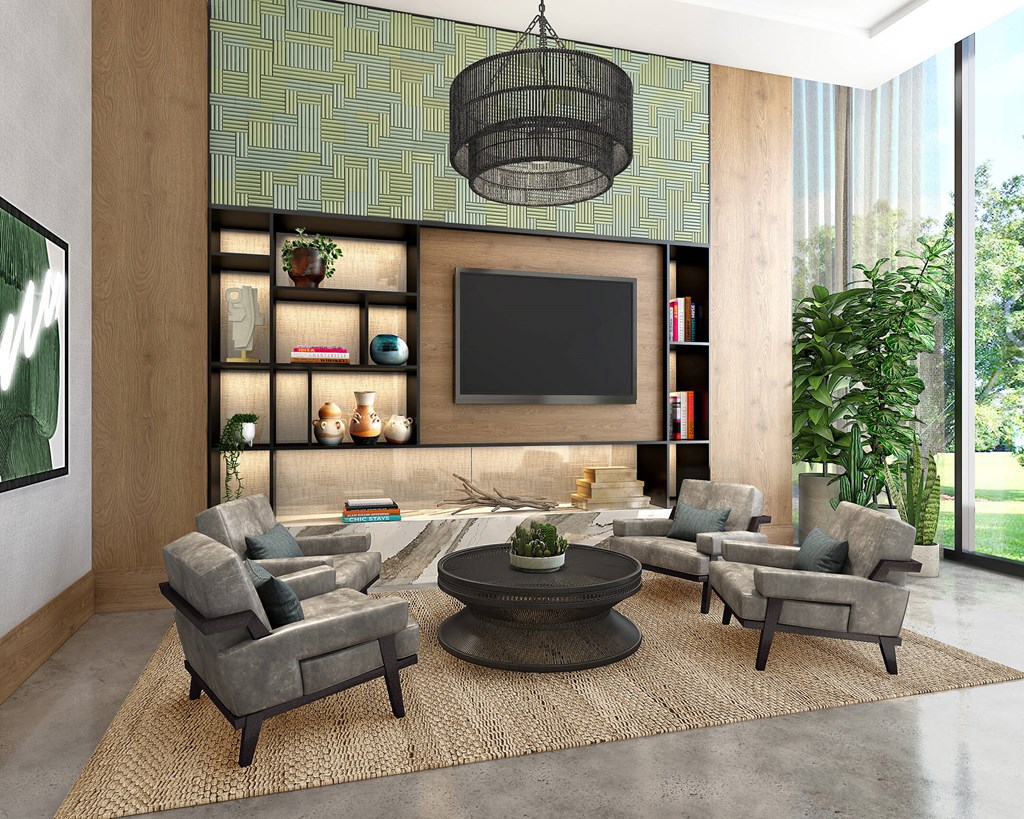 A modern living room with a grey sofa set, a coffee table, and a large flat screen TV mounted on the wall.