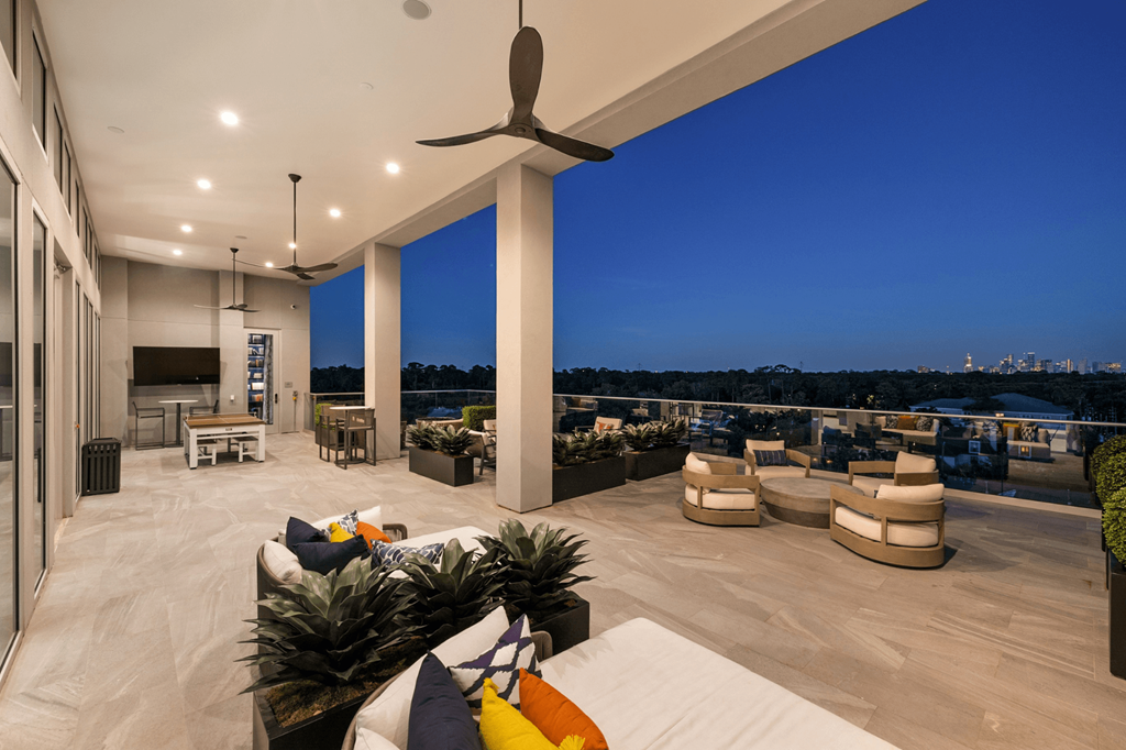 A modern outdoor living space with a view of the city skyline.
