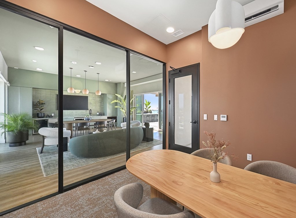a dining room with a wooden table and chairs