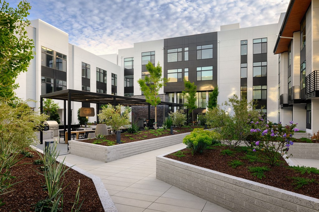 a rendering of an apartment building with a courtyard