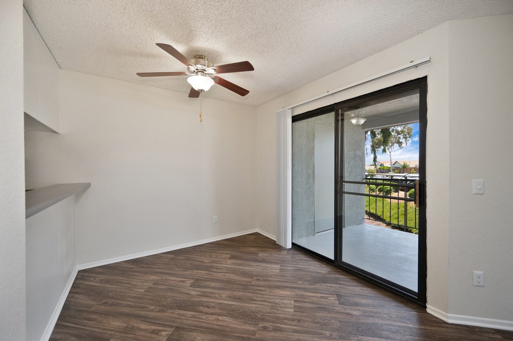 a 1-bedroom apartment dining area with a sliding glass door and a ceiling fan