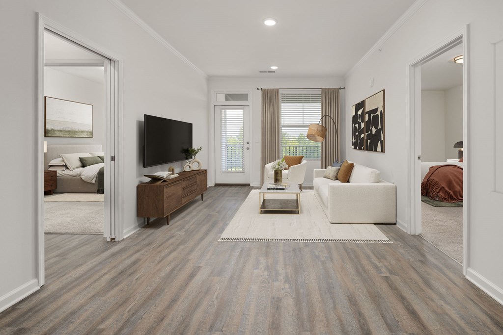 A modern living room with a white couch and a wooden floor.