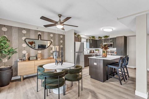 A modern kitchen with a dining table and chairs.