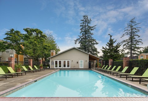 A swimming pool with lounge chairs