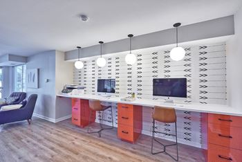 A white desk with a computer and monitor on it.