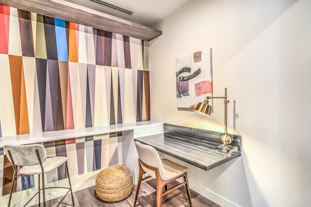 a home office with a desk and two chairs