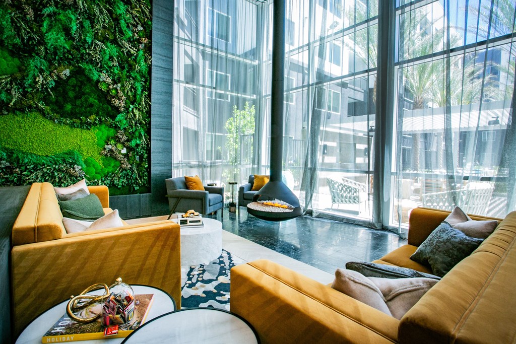 Clubhouse Lounge sitting area with yellow couches green accent wall