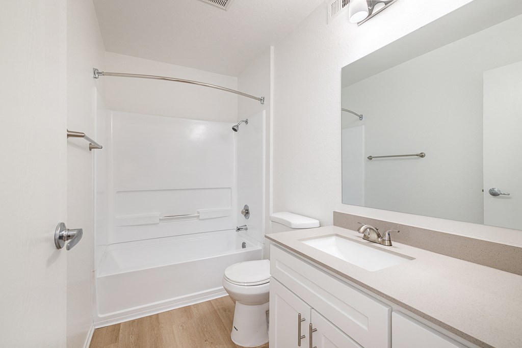 a bathroom with a toilet sink and shower