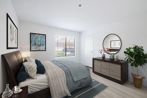 a bedroom with a bed and dresser in a 555 waverly unit