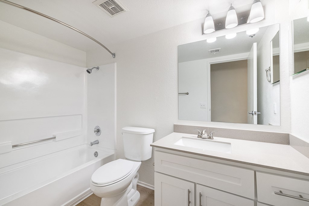 a bathroom with a bathtub and a sink