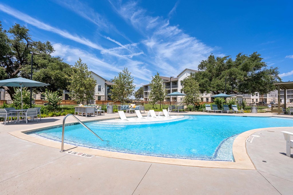 our apartments have a large pool with chairs and umbrellas