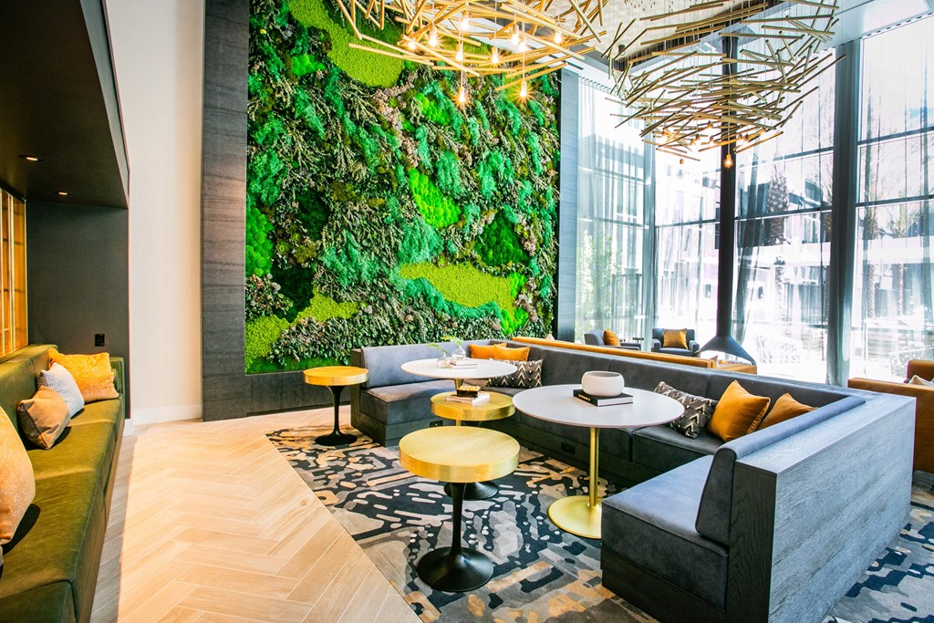 Clubhouse Lounge sitting area with yellow couches green accent wall