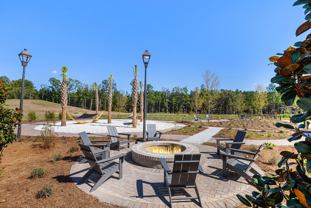 a fire pit with chairs and tables  and the hammock garden