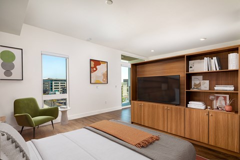 a bedroom with a bed and a tv