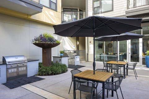 Communal grilling stations by the apartment pool