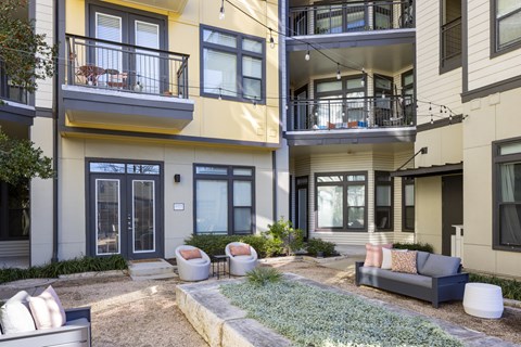 Lounge furniture in a peaceful courtyard by apartment homes
