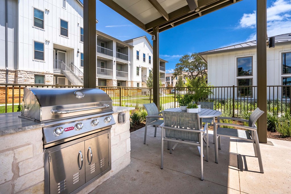 our apartments have a patio with a grill and table