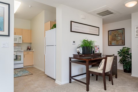 A kitchen with a table and chairs in the middle of the room.