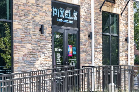 A brick building with a sign that says Pixel Bar & Grill.