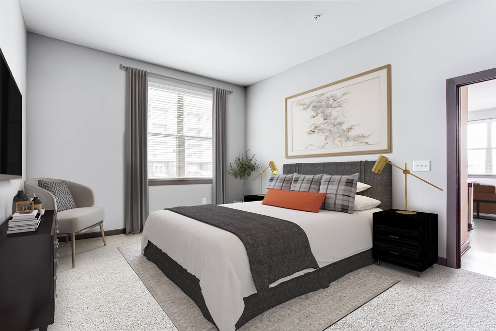 a bedroom with a large bed and a large window