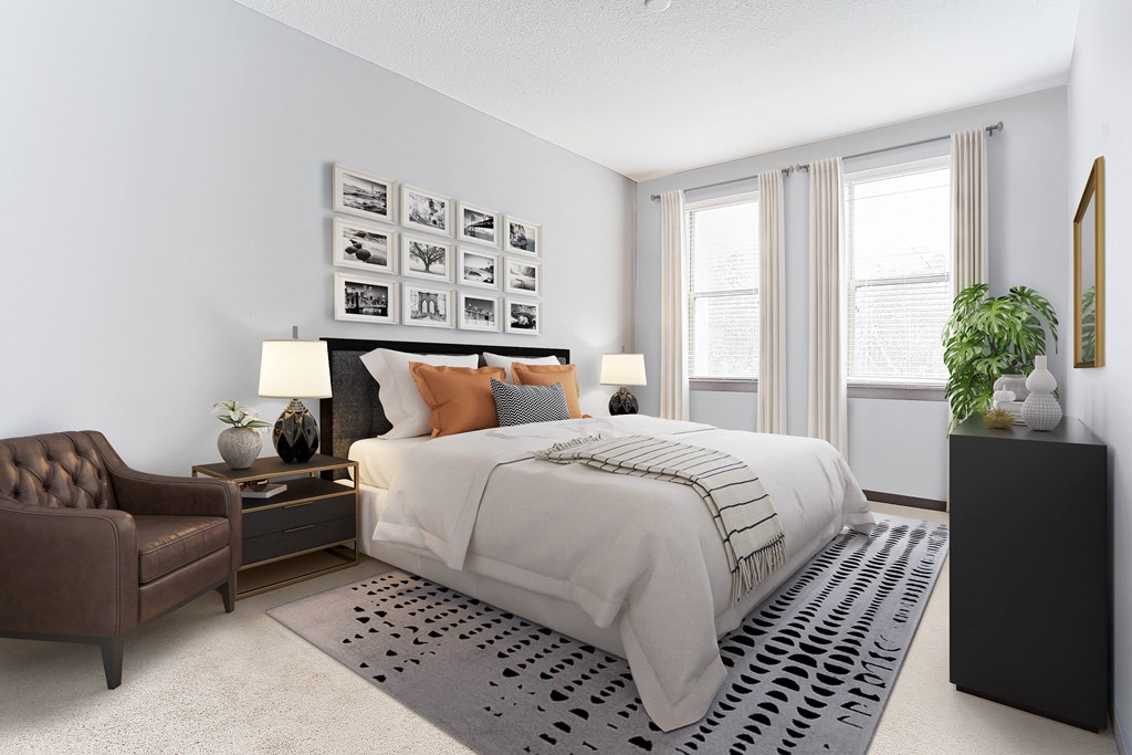 a bedroom with a bed and a chair in a 555 waverly unit