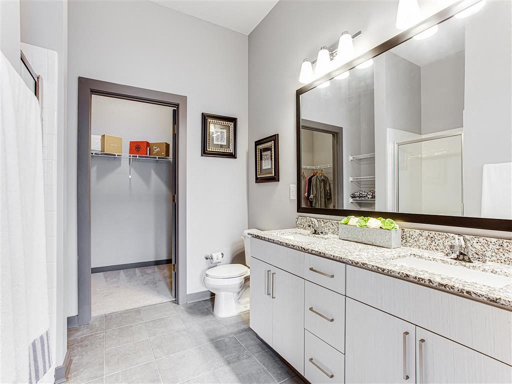 a bathroom with a toilet a sink and a mirror