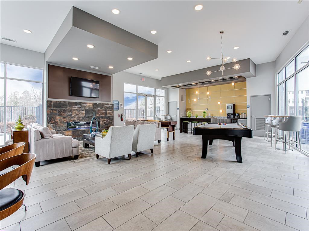 a large living room with a pool table in the middle of it