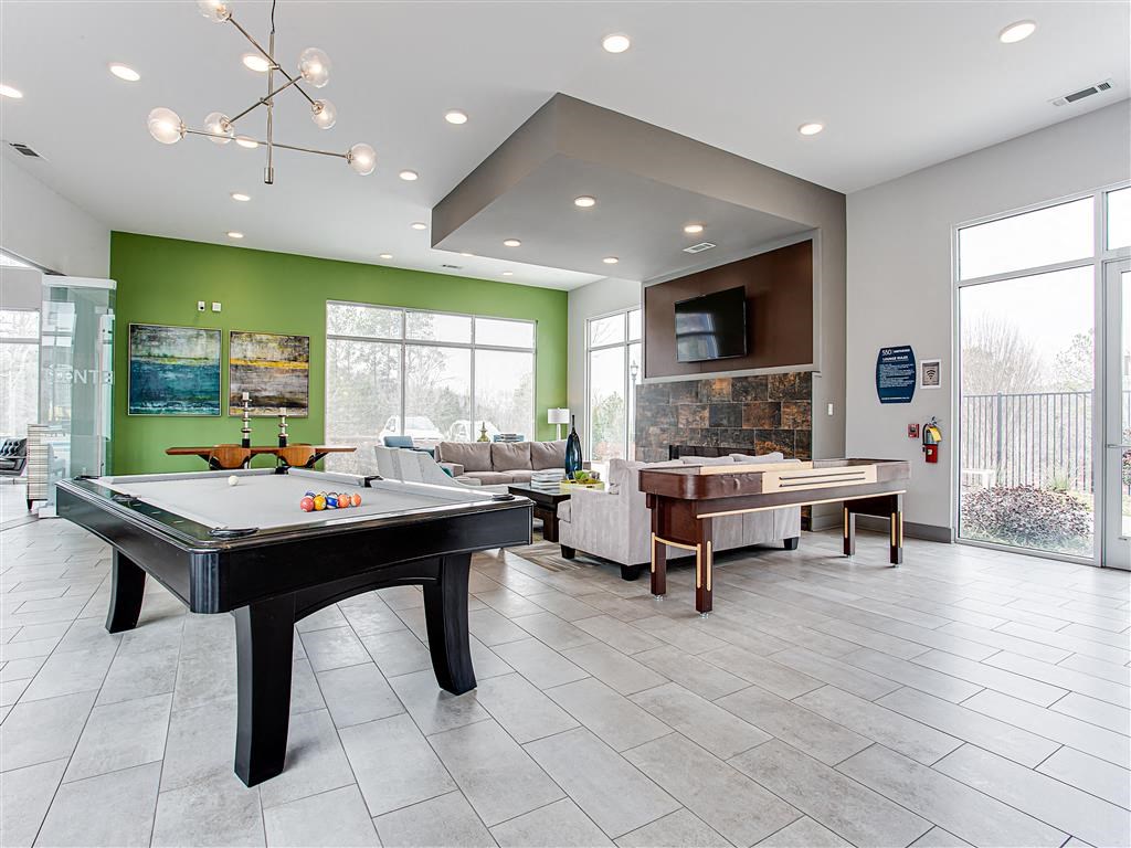 a game room with a pool table and foosball
