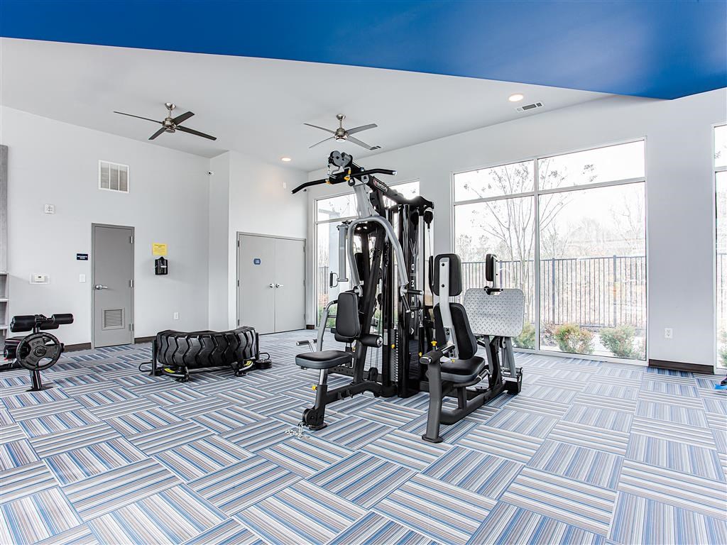 a home gym with exercise equipment and a large window