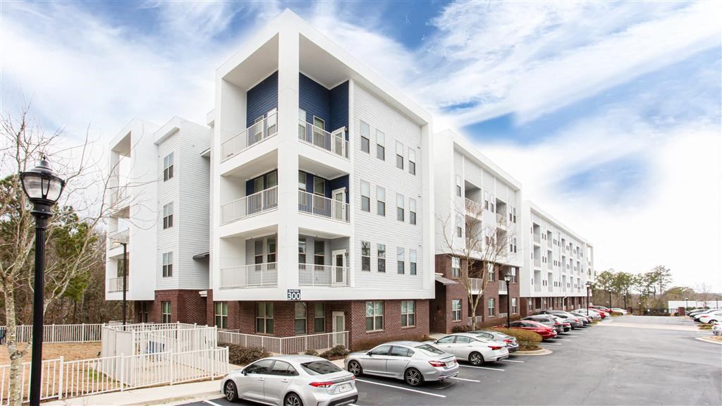 a large white building with a parking lot in front of it