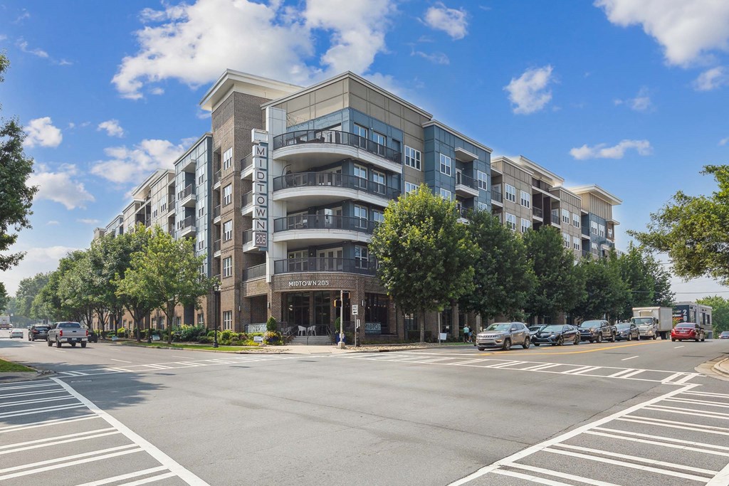 a large apartment building with balconies and a sign on the side of the building that reads