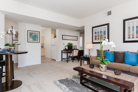 A living room with a brown couch and a coffee table.