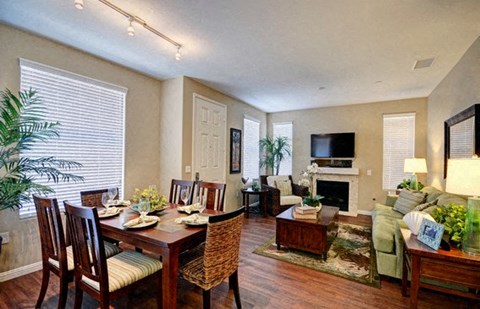 A dining room with a wooden table and chairs.
