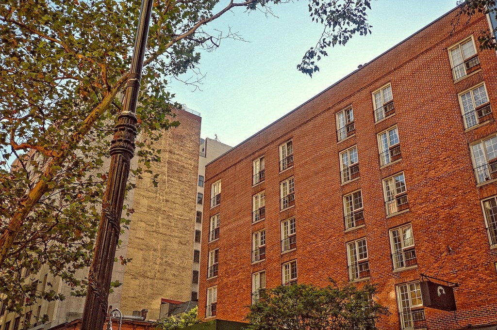 a tall brick building next to a shorter brick building