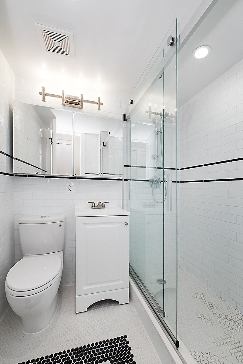 a bathroom with a toilet sink and shower
