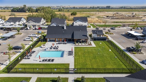 A large building with a pool in front of it.