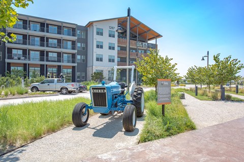 a blue tractor parked in front of a building