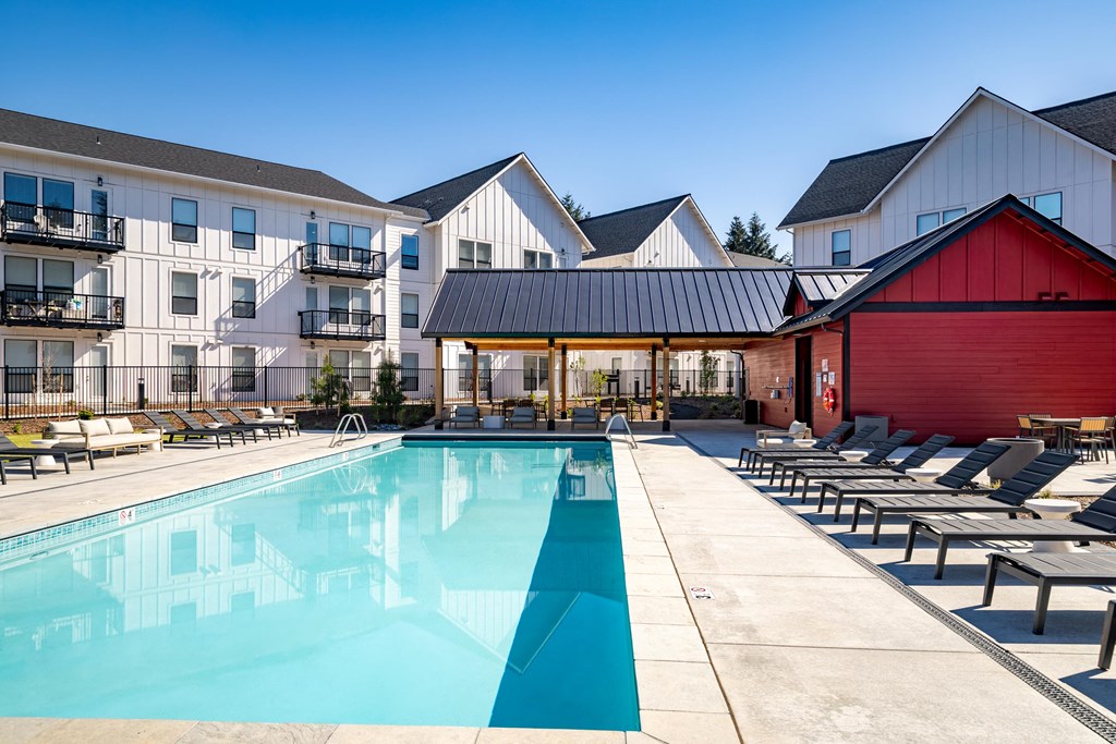 our apartments have a large pool and lounge chairs at The Farmstead, Washington