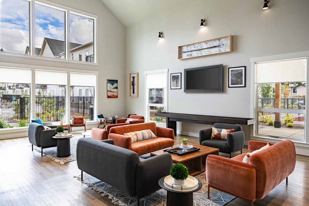 a living room with couches and chairs and a television at The Farmstead, Washington, 98684