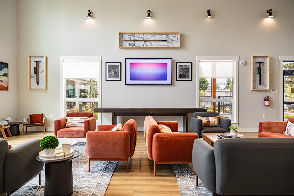 a living room with couches and chairs and a tv on the wall at The Farmstead, Vancouver, 98684