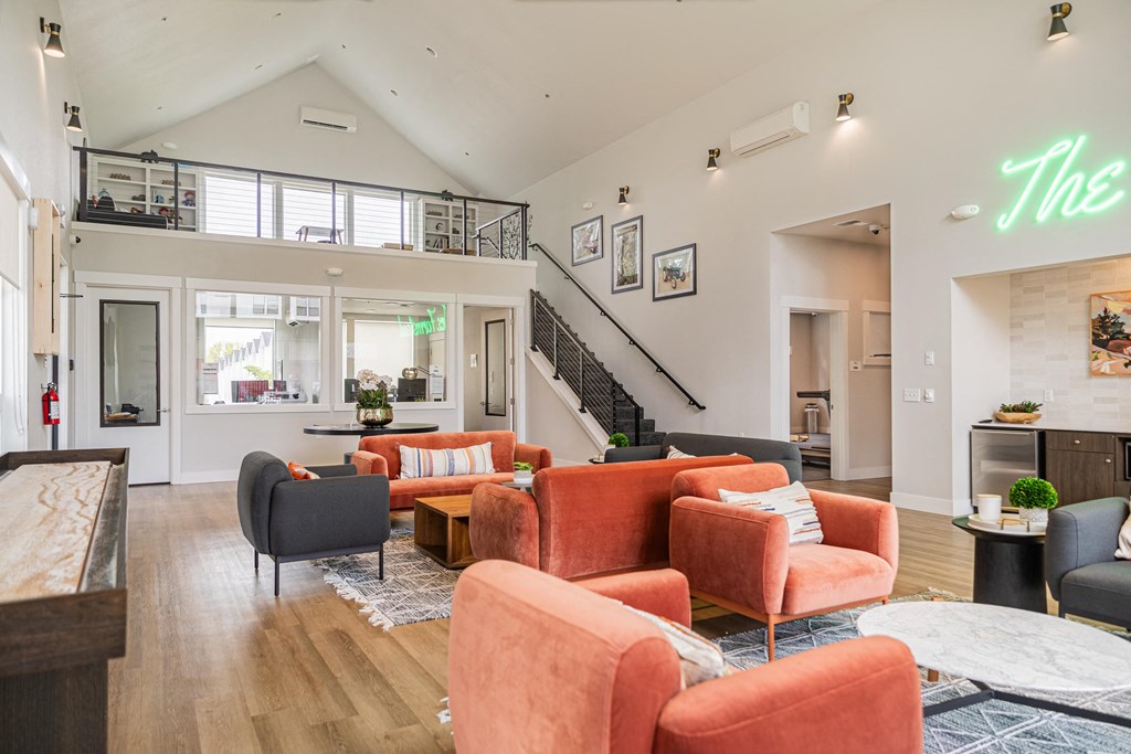 a living room with couches and chairs and a staircase at The Farmstead, Vancouver