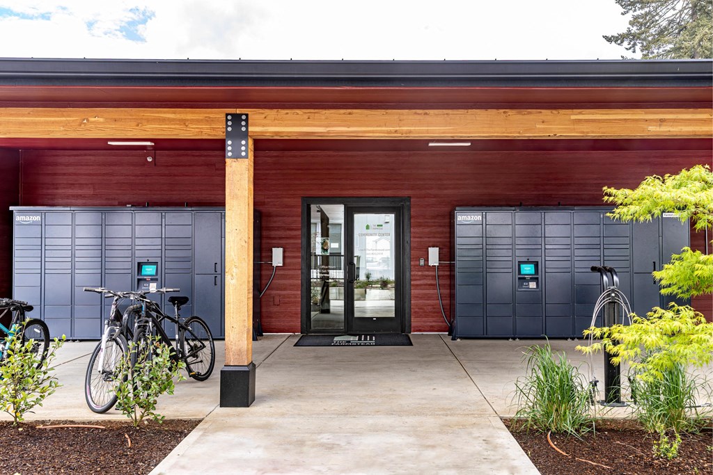 the front of a red building with two doors and two bikes parked outside at The Farmstead, Vancouver