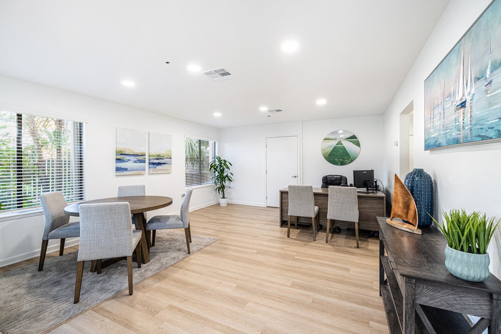 a living room with a dining room table and chairs