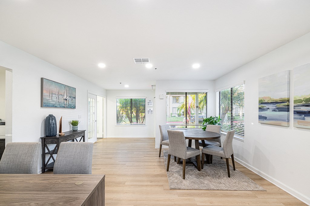 a living room with a dining room table and chairs