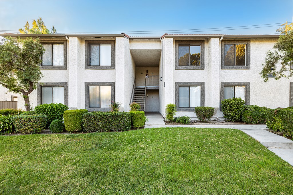 a white house with a lawn in front of it